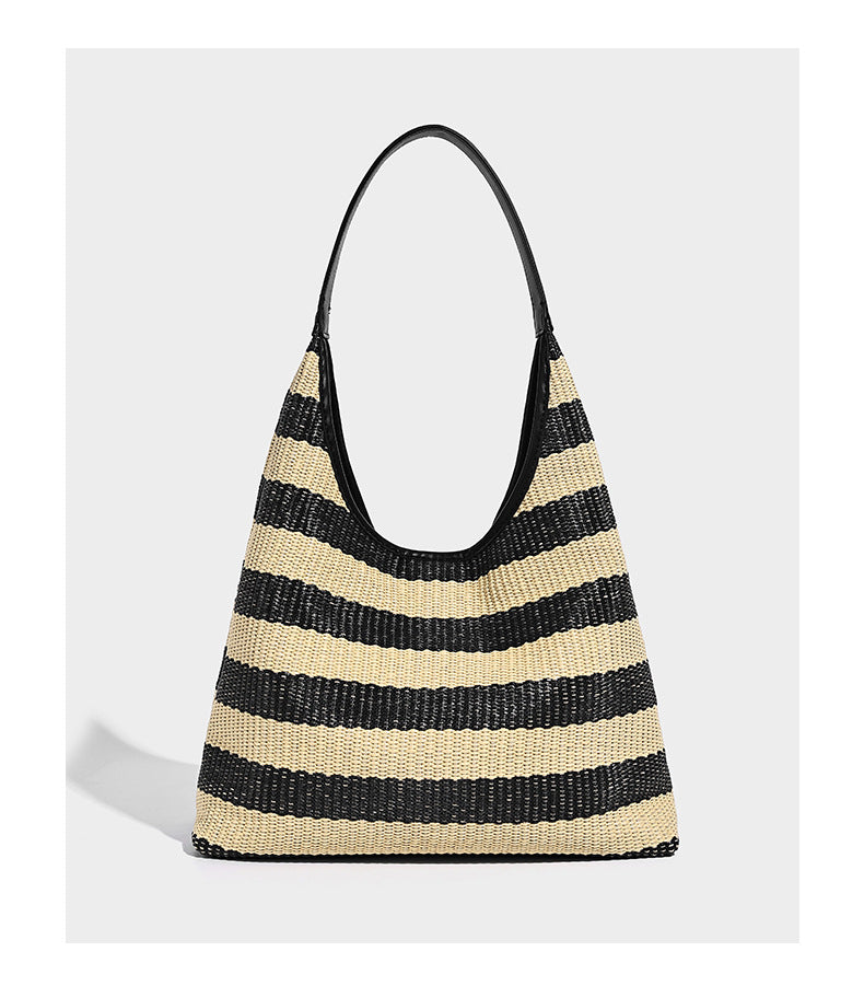 Black and beige striped woven shoulder tote bag with leather-look trim and detachable black zip pouch, detail view 9