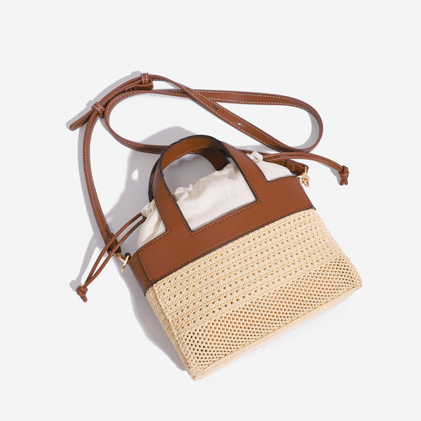 Small woven open-weave bucket bag with brown leather-look trim, cream gathered drawstring lining, dual top handles, and