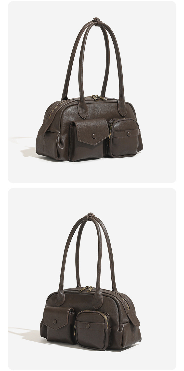 Structured retro bowling-style top-handle handbag with dual zip closure, front snap-flap pocket, and front zip pocket, detail