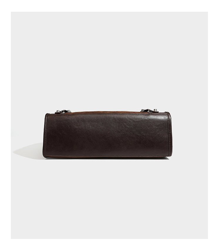 Large structured tote bag with matte suede-like body, smooth leather-look trim, front zip pocket, stud hardware, and