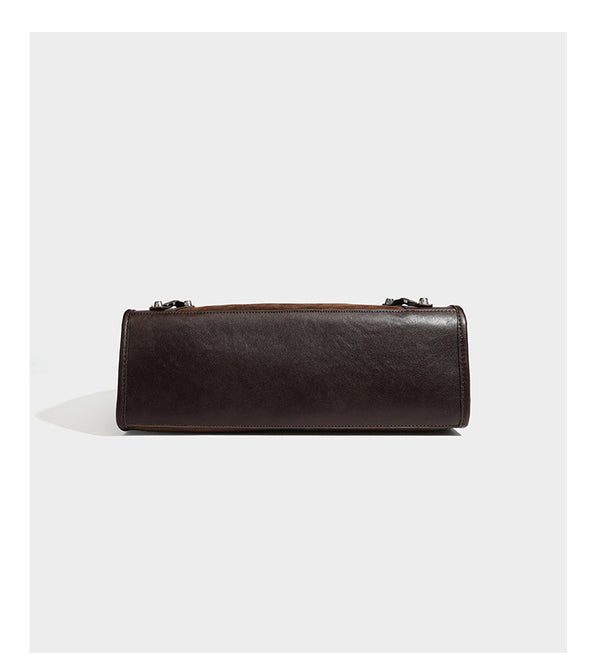 Large structured tote bag with matte suede-like body, smooth leather-look trim, front zip pocket, stud hardware, and