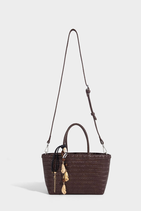 Structured chevron woven leather-look tote bag with braided top handles, gold feather charm, and adjustable shoulder strap