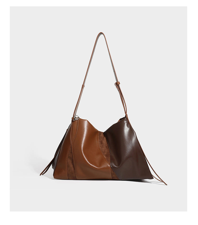 Two-tone black and brown leather-look slouchy shoulder bag with beaded tassel charm and silver-tone hardware, detail view 15
