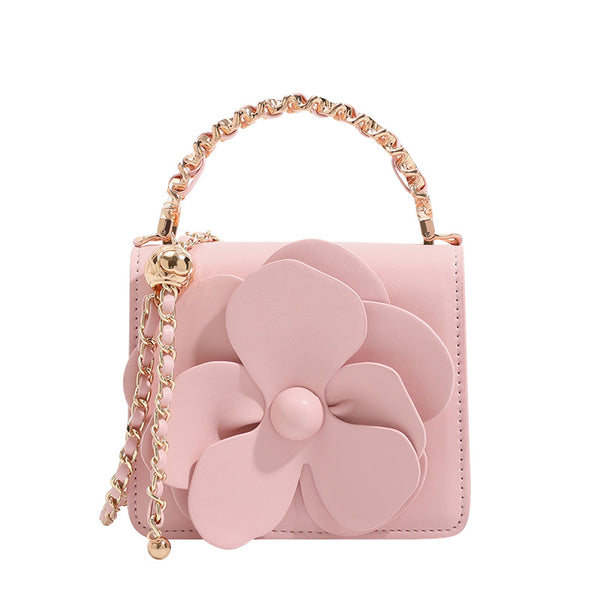 Small structured rectangular crossbody bag with layered 3D flower appliqué and gold-tone chain strap, detail view 5