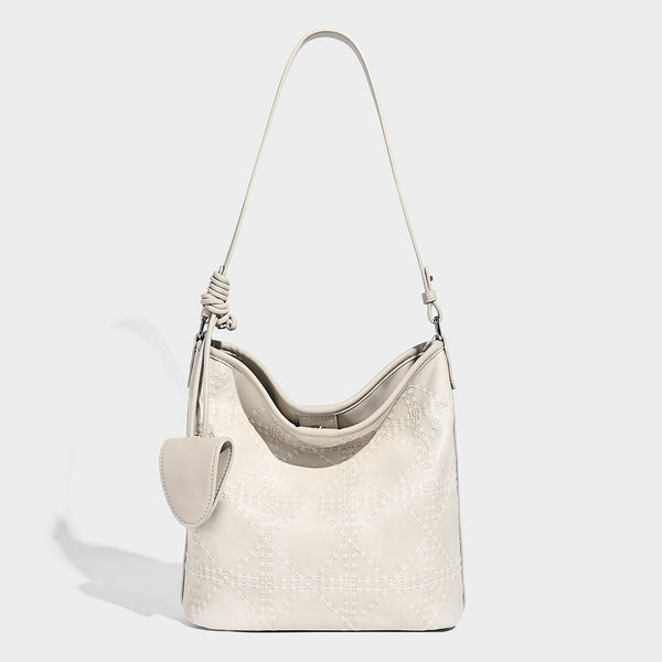 Diamond-quilted leather-look bucket shoulder bag with knotted strap accent and attached mini pouch, detail view 6