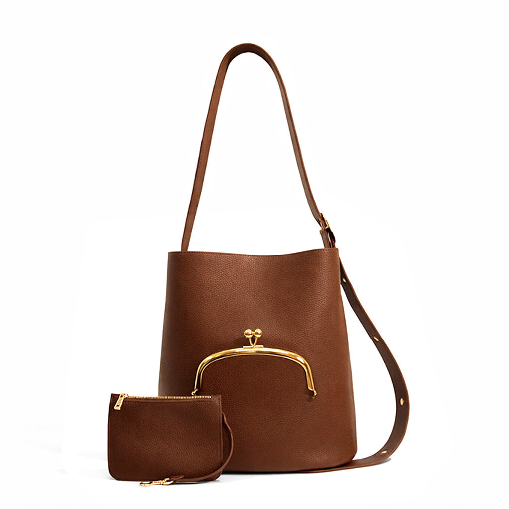 Pebbled textured bucket bag with gold-tone kiss-lock front pocket and adjustable single shoulder strap, detail view 15