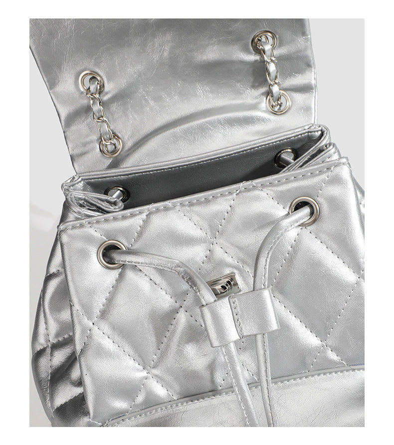 Quilted leather-look backpack with heart turn-lock clasp and woven chain handles, detail view 11