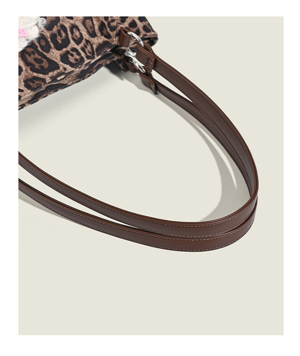 Leopard-print fabric tote bag with white plush teddy bear appliqué and brown leather-look shoulder straps, detail view 14