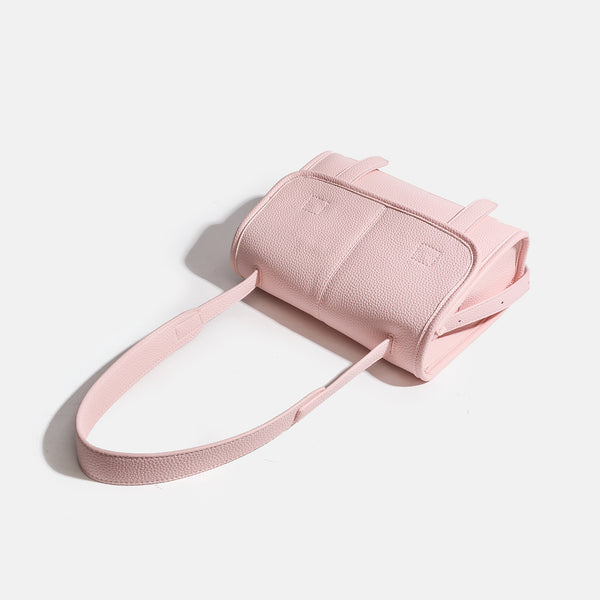 Compact structured flap satchel bag with pebbled texture, snap closure, front strap tabs, and long adjustable crossbody
