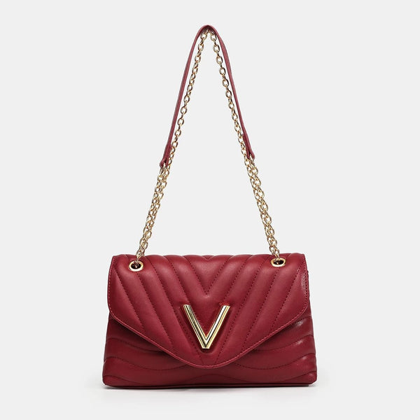 Small structured diamond-quilted flap shoulder bag with gold-tone V-shaped hardware and chain strap, front view