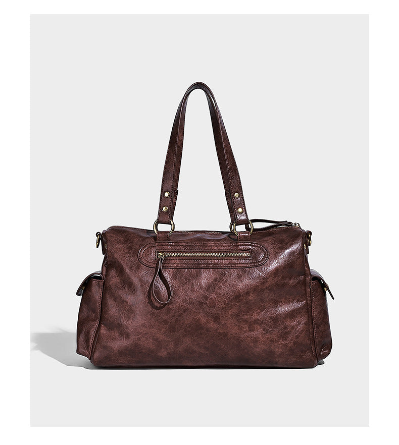 Distressed leather-look vintage satchel shoulder bag with multiple front zip pockets, dual top handles, and brass-tone
