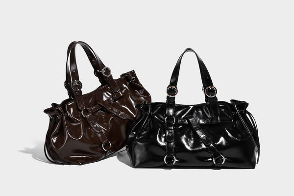 Glossy patent-look slouchy tote bag with ruched drawstring sides, dual top handles, silver ring hardware, and detachable