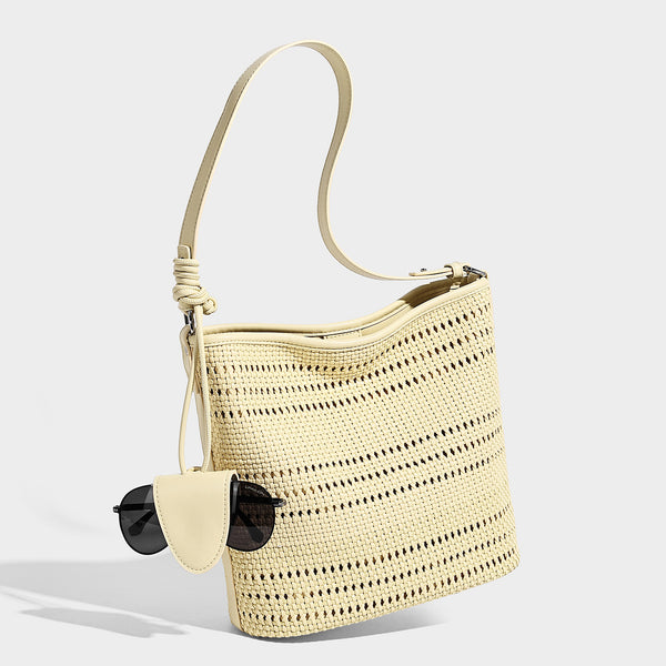 Handwoven open-weave shoulder bag with leather-look trim, knotted adjustable strap, and clip-on sunglasses sleeve pouch