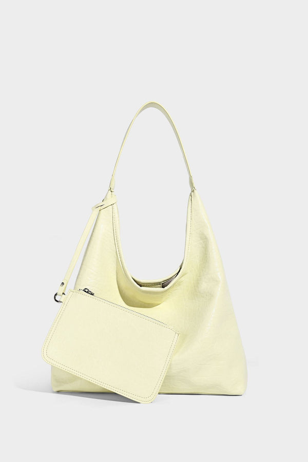 Slouchy hobo shoulder bag in pale yellow glossy pebbled leather-look finish with single shoulder strap and detachable front