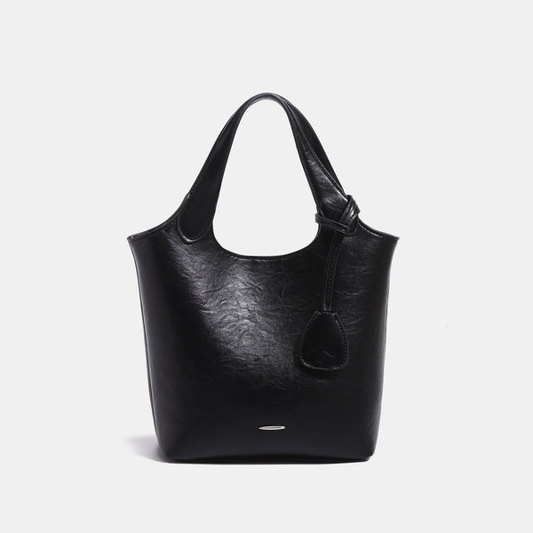 Soft glossy leather-look bucket tote bag with twin handles and detachable crossbody strap, detail view 8