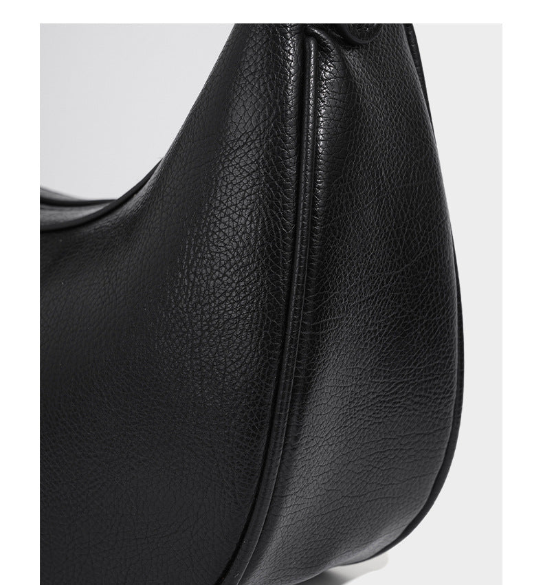 Crescent half-moon shoulder bag in pebbled leather-look finish with adjustable strap and silver-tone hardware, detail view 14