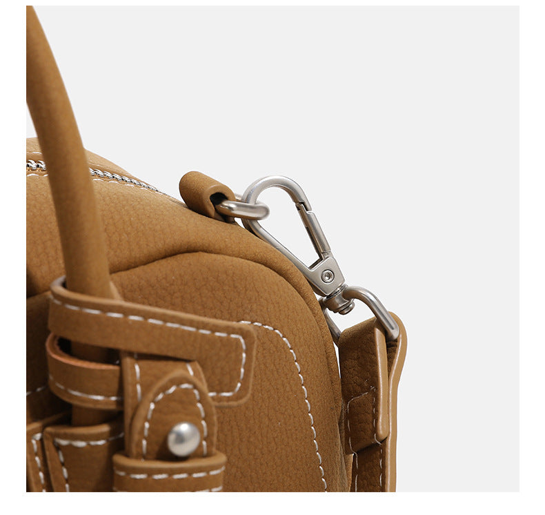 Compact retro Boston satchel bag with matte suede-look finish, twin rounded top handles, double zip closure with silver-tone