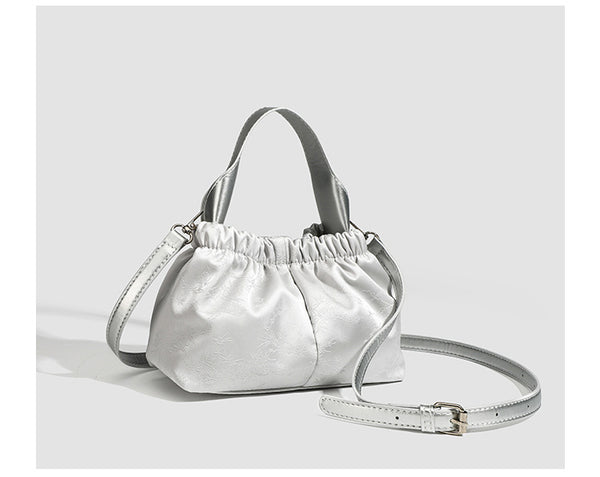 Small ruched satin-finish cloud bag with elasticized drawstring top, short top handle, and chunky silver-tone chain strap