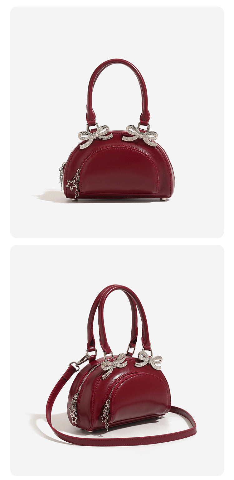 Structured half-moon mini handbag with silver-tone crystal bow hardware and star charm chain, detail view 9