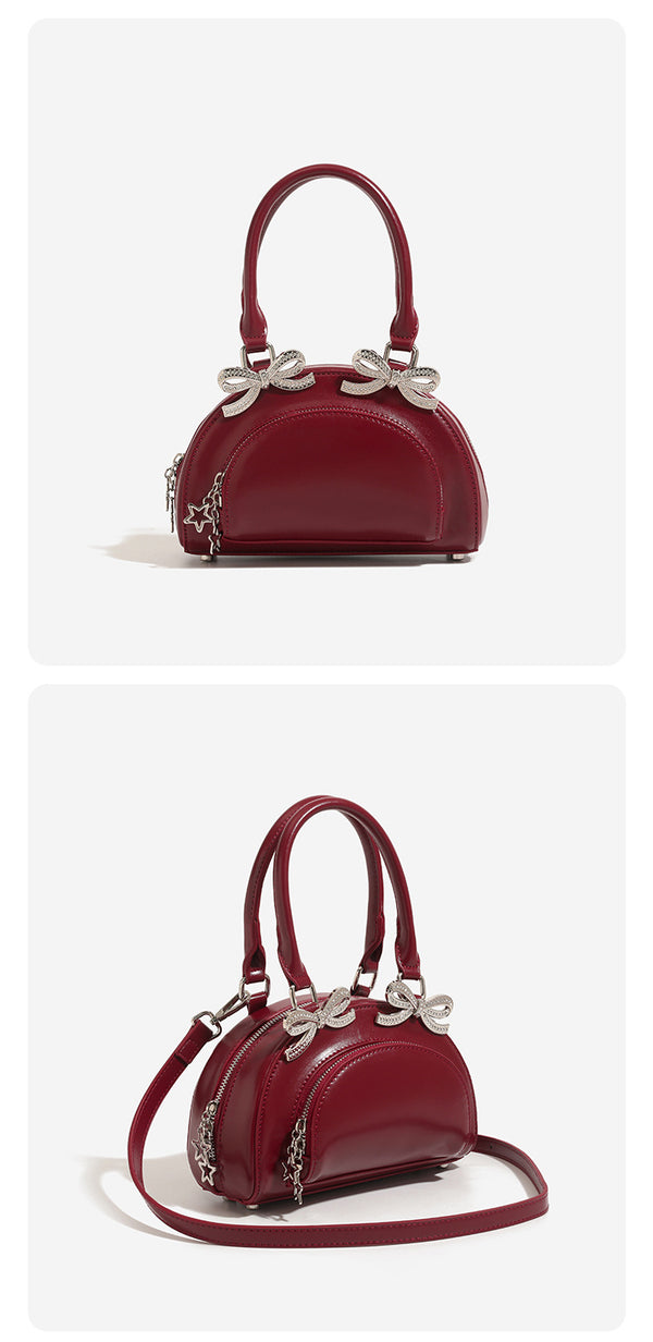 Structured half-moon mini handbag with silver-tone crystal bow hardware and star charm chain, detail view 9