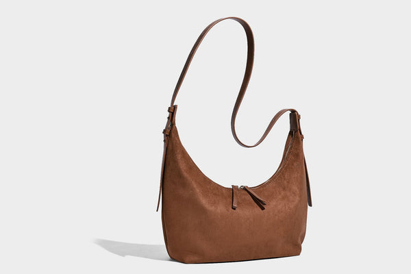 Slouchy crescent hobo shoulder bag in dark chocolate matte suede-look finish with adjustable strap and twin-pull top zip
