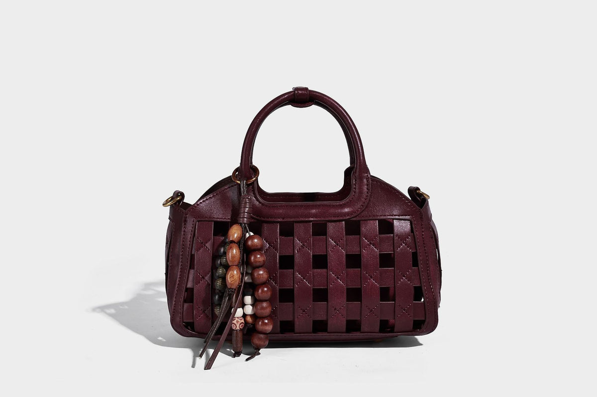 Small structured woven lattice top-handle satchel bag with bead-and-tassel charm and gold-tone hardware, detail view 31