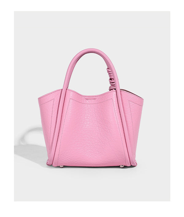 Structured mini tote bag in pebbled leather-look finish with knotted top handles, front flap pocket, and detachable shoulder