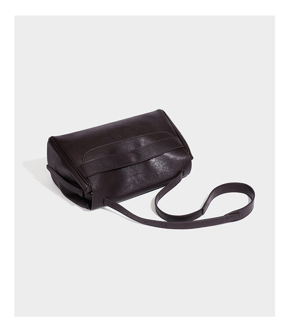 Structured rectangular flap shoulder bag in dark brown leather-look finish with long single strap and layered front panel