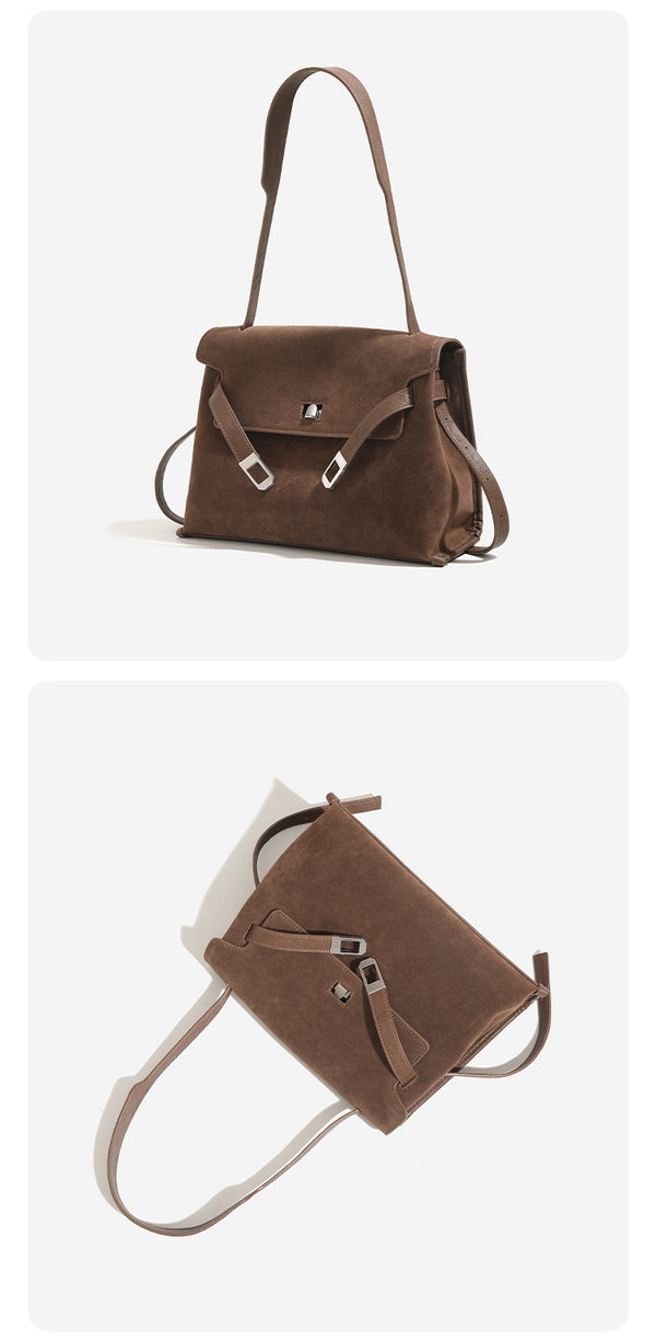 Structured trapezoidal flap satchel bag with silver-tone turn-lock clasp, decorative front strap tabs, gusseted sides, and