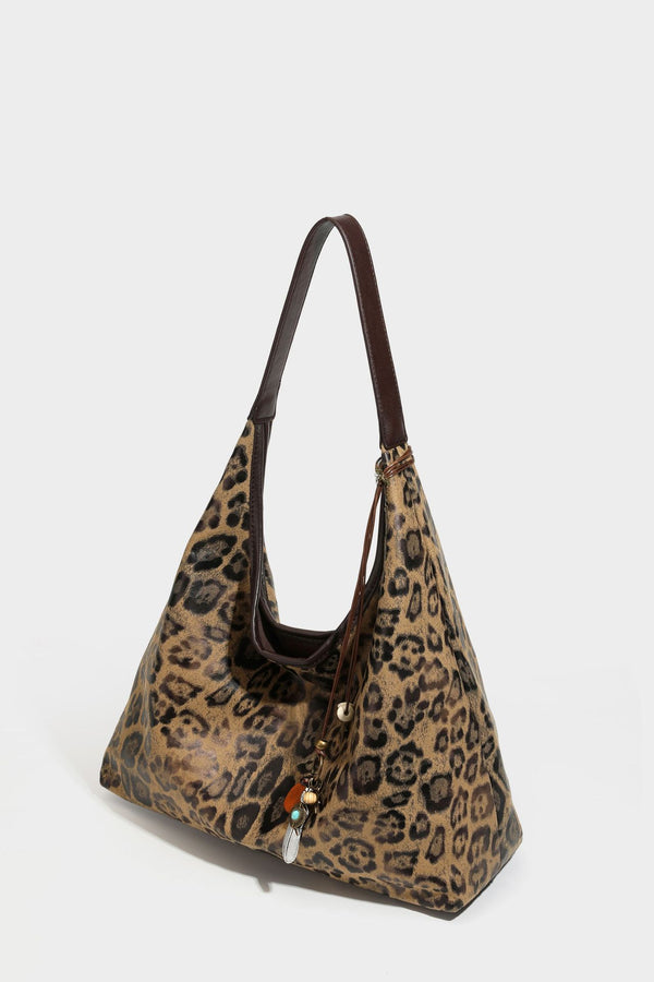 Weich fallende Hobo-Tote-Bag mit Leopardenmuster in Beige und Braun, dunkelbraunem Riemen in Lederoptik und herabhängenden Perlenanhänger-Beschlägen