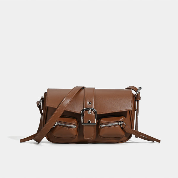 Structured flap crossbody bag with front buckle strap and dual zip pockets in smooth leather-look finish with silver-tone