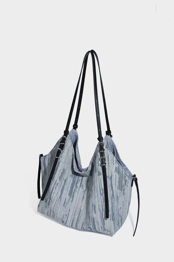 Large slouchy woven-texture shoulder tote bag with slim leather-look straps, side cinch ties, and silver-tone hardware
