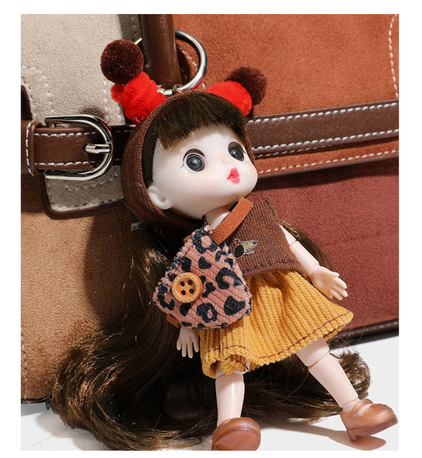 Structured color-block satchel bag in brown, rust, beige, and taupe suede-look panels with white topstitching, front buckle