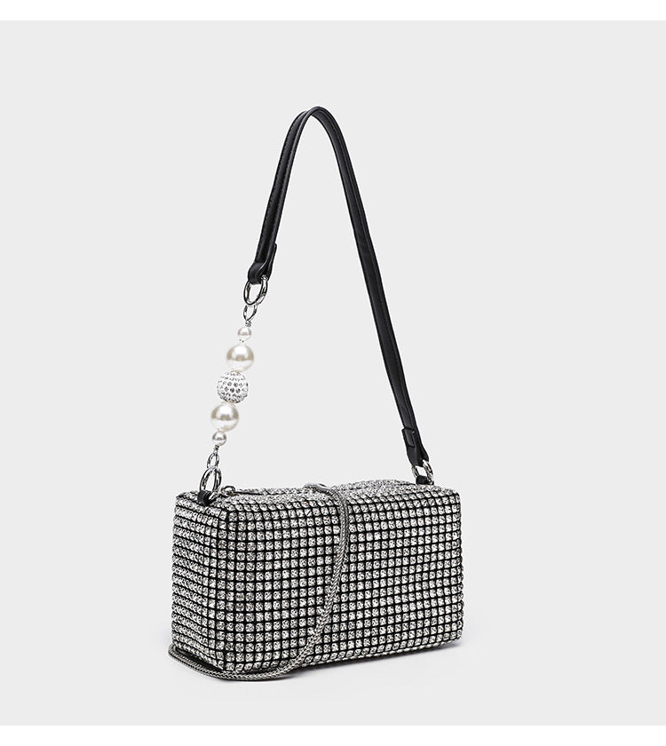 Small rectangular all-over rhinestone crossbody bag with pearl bead zipper pull and detachable silver chain strap, detail