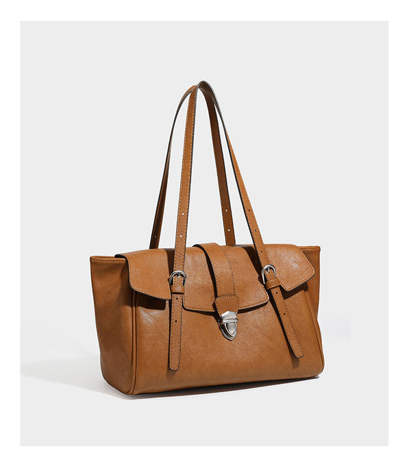 Large structured vintage-style tote bag with flap-front turn-lock closure, twin buckle straps, and double shoulder handles
