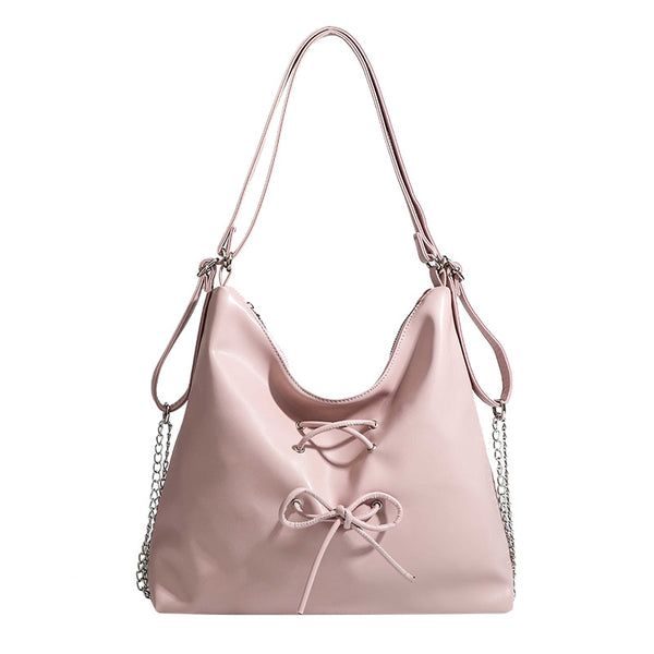 Glossy leather-look hobo shoulder bag with front bow lacing detail and silver-tone chain strap, detail view 5