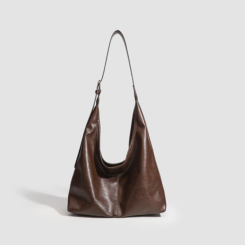 Large slouchy hobo shoulder bag in smooth leather-look finish with adjustable strap and gold-tone hardware, front view