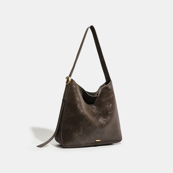 Large slouchy hobo tote bag in distressed dark brown leather-look finish with long shoulder strap, gold-tone ring hardware
