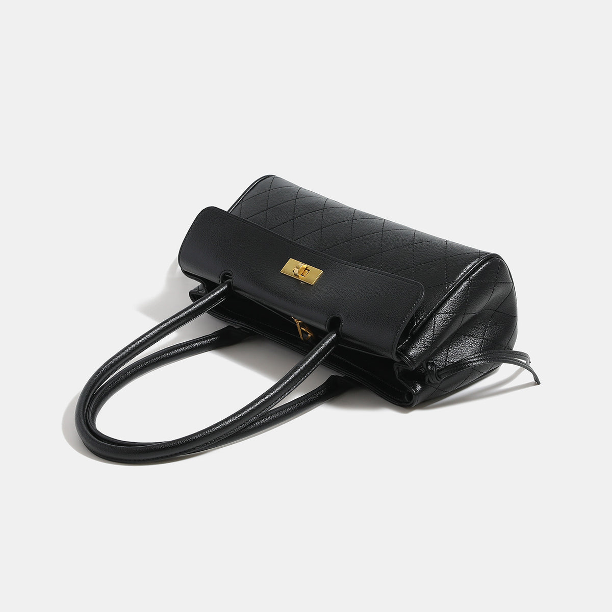 Structured quilted diamond-stitch baguette handbag with gold-tone turn-lock closure and dual top handles, detail view 4