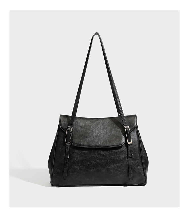 Large structured shoulder tote bag in wine red textured leather-look finish with front flap closure and silver-tone buckle