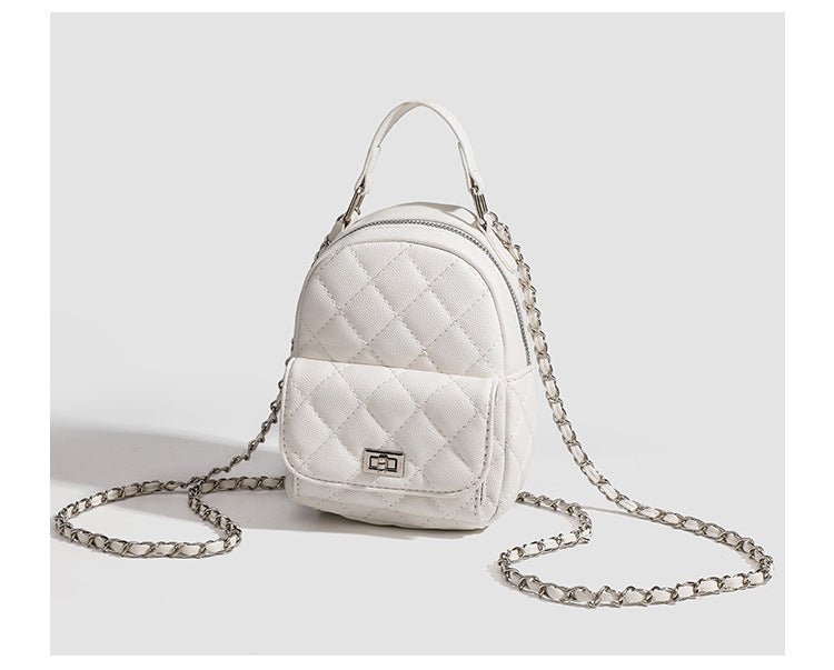 Compact diamond-quilted mini backpack handbag with silver-tone chain straps and turn-lock front pocket, detail view 12