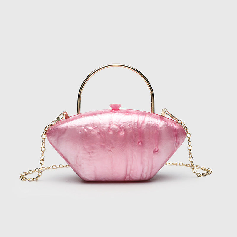 Shell-shaped pearlescent top-handle clutch bag with arched gold-tone metal handle and gold chain strap, detail view 9