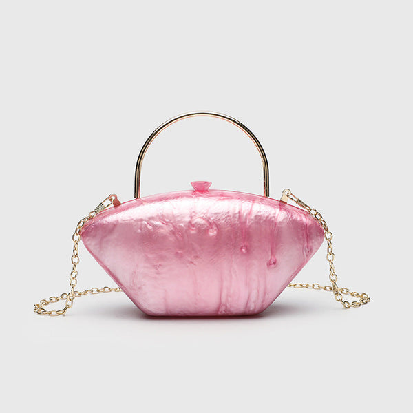 Shell-shaped pearlescent top-handle clutch bag with arched gold-tone metal handle and gold chain strap, detail view 9