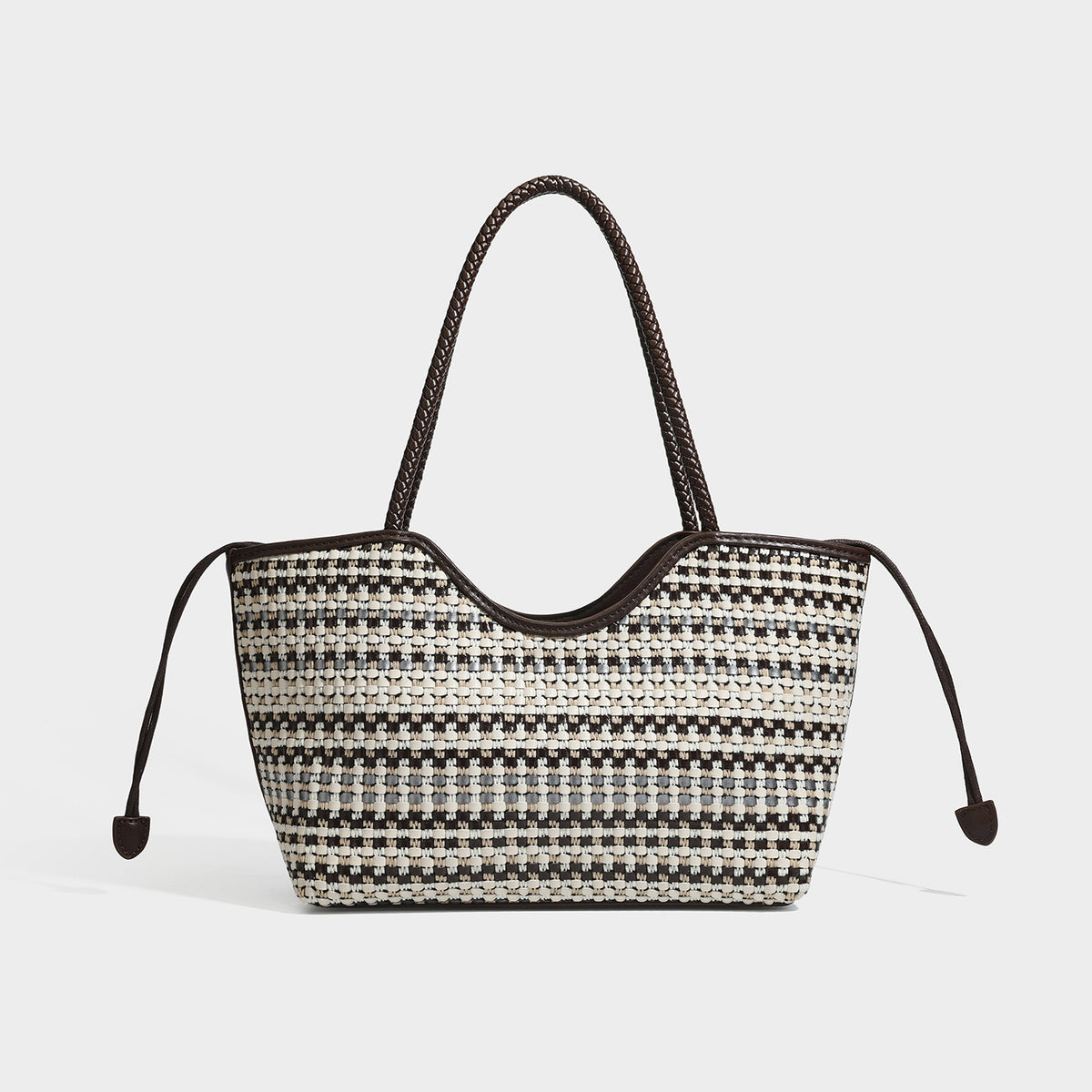 Large woven checker-pattern tote bag with dark braided shoulder straps, leather-look trim, and drawstring side ties, detail
