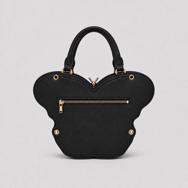 Schwarze Handtasche in Schmetterlingsform mit rosafarbenem Print auf den Flügelpartien und goldfarbenem, skulpturalem Reißverschlussanhänger in Form eines Schmetterlingskörpers, Detailansicht 3