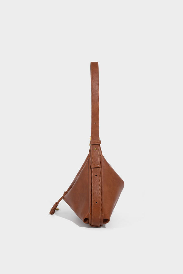 Slouchy brown leather-look shoulder bag with knotted drawcord tie closure, gold-tone ring hardware, and long adjustable