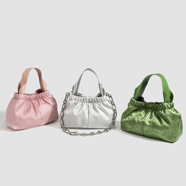 Small ruched satin-finish cloud bag with elasticized drawstring top, short top handle, and chunky silver-tone chain strap