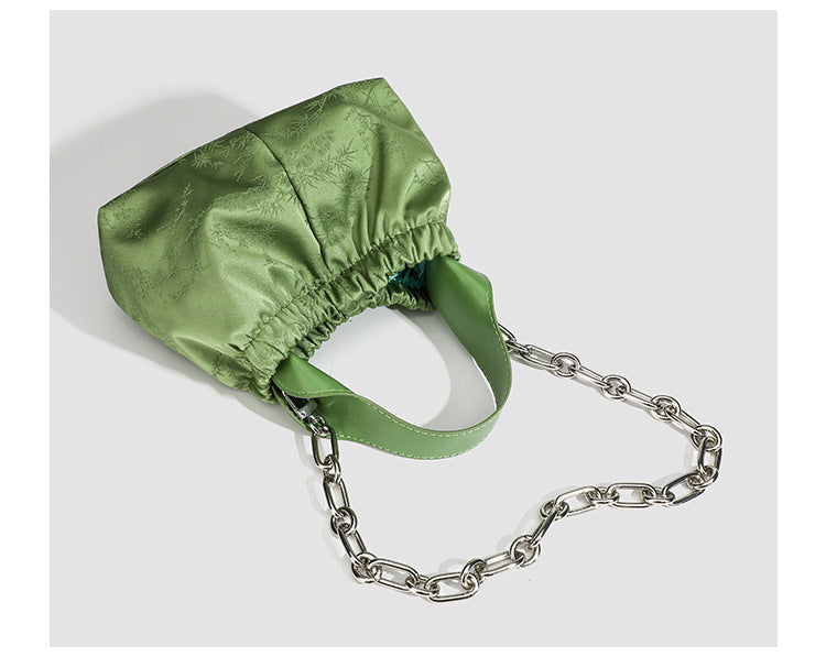 Small ruched satin-finish cloud bag with elasticized drawstring top, short top handle, and chunky silver-tone chain strap