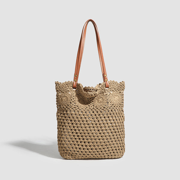 Woven crochet shoulder tote bag with scalloped floral top edge, tan leather-look straps, and antique gold rivets, detail view