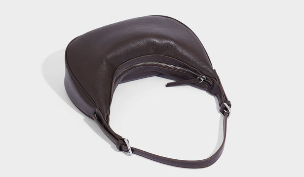 Crescent half-moon shoulder bag in pebbled leather-look finish with adjustable strap and silver-tone hardware, detail view 33